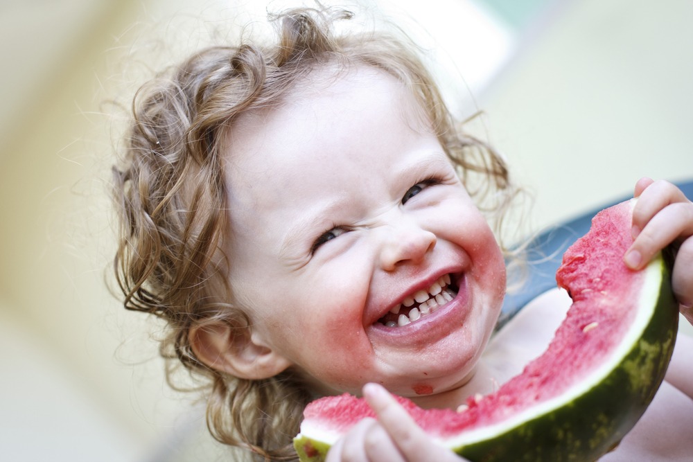 A Little Girl Finishing a Slice of Watermelon
